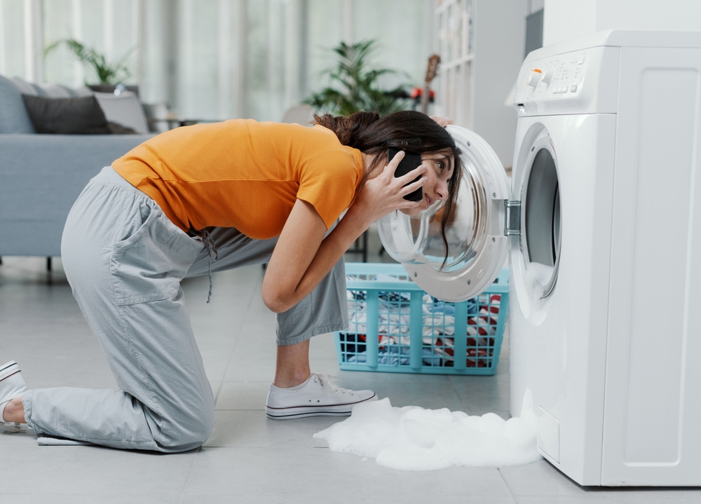 Worried,Woman,Calling,A,Repairman,,The,Washing,Machine,Is,Broken