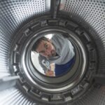 Repairman,Fixing,A,Washing,Machine,,View,From,The,Inside,Of