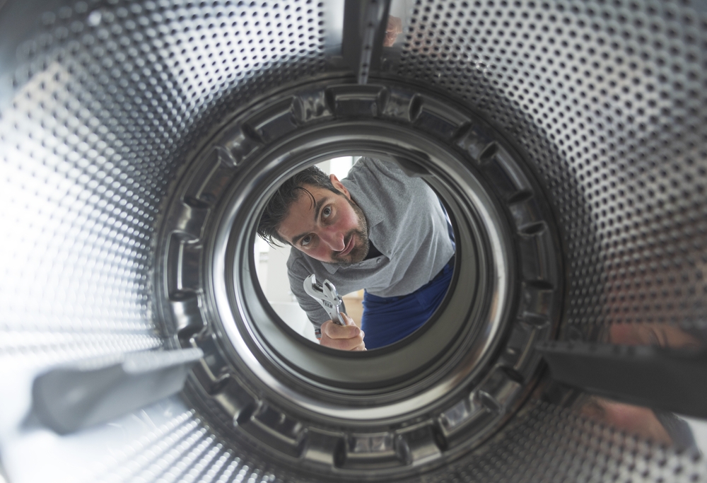 Repairman,Fixing,A,Washing,Machine,,View,From,The,Inside,Of